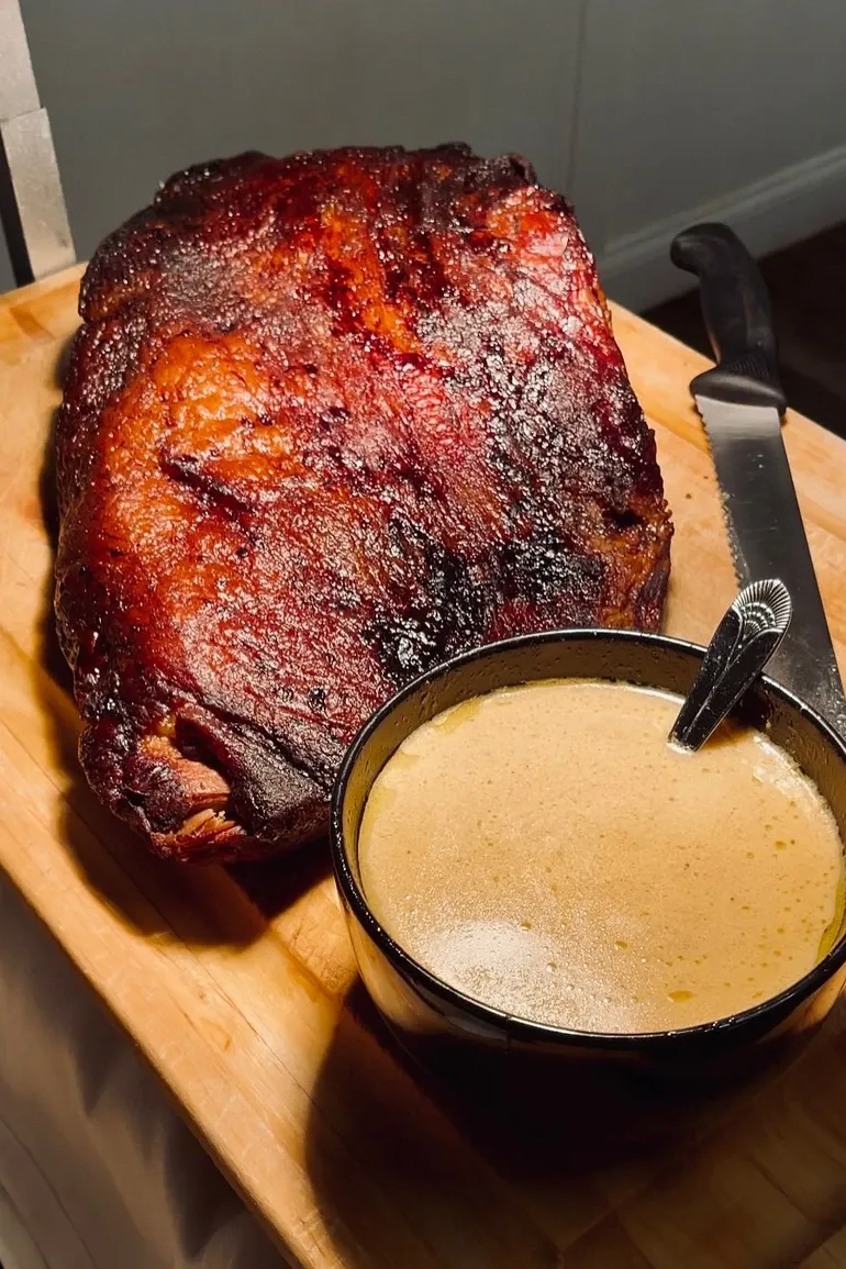 Smoked prime rib with a bowl of au jus