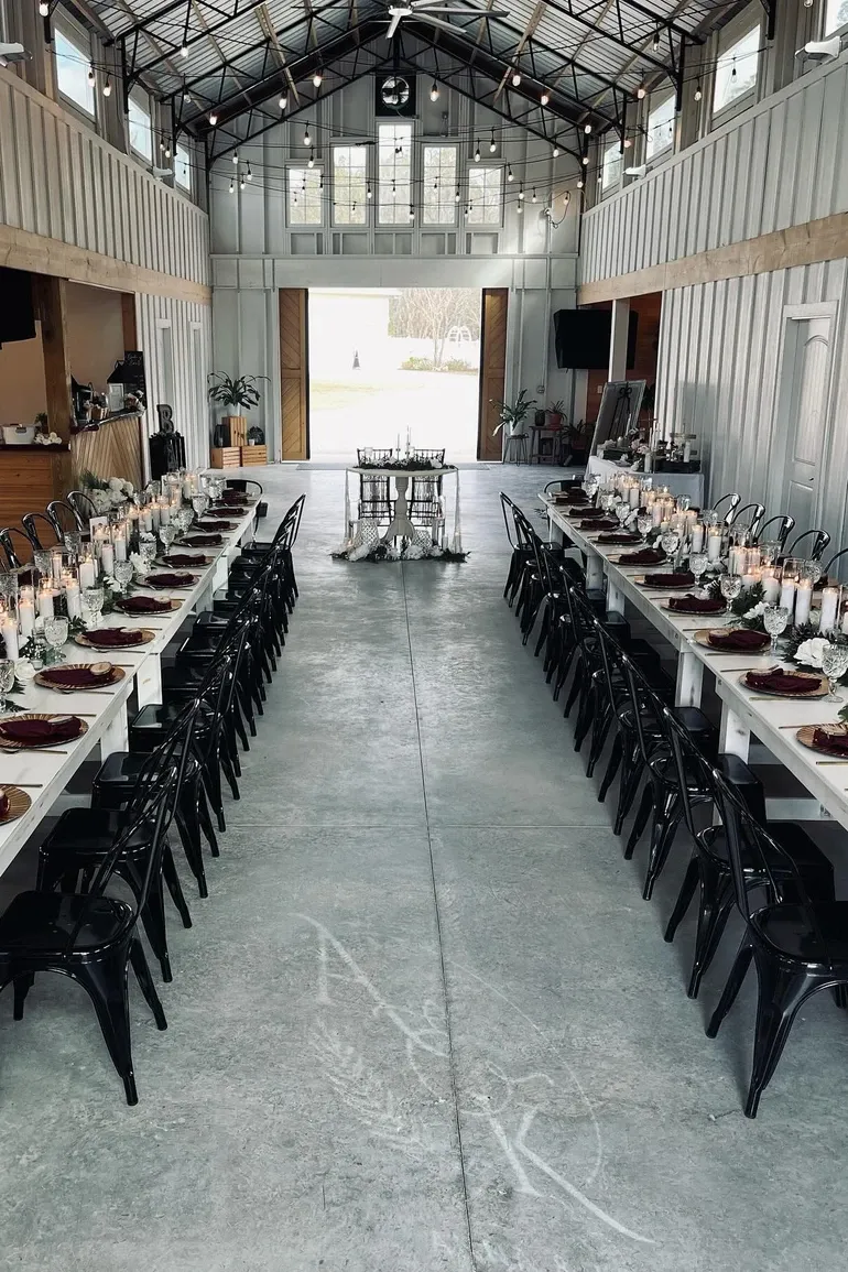 Long white tables leading to open barn doors